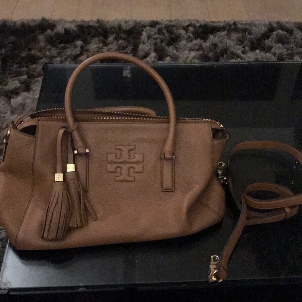 Brown Tory Burch midsize purse with strap.